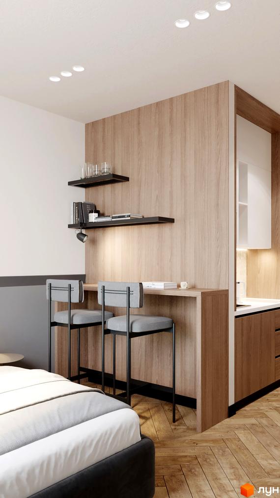 Інтер'єр апартаментів в Апарт-готелі WOL Vinnytsia. Барна стійка з двома стільцями, полиці з декором, ліжко з білою постіллю.