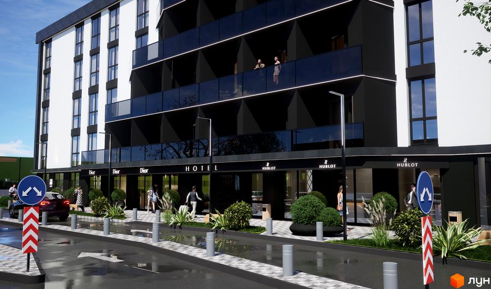 Зовнішній вигляд апарт-готелю WOL Vinnytsia з чорними фасадами та скляними балконами. На першому поверсі розташовані бутики та зелені насадження.