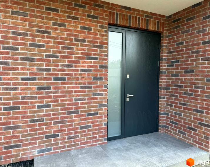 Фасад таунхаусу Loft House з цегляним оздобленням та темними дверима. Вхідна група та прибудинкова територія.