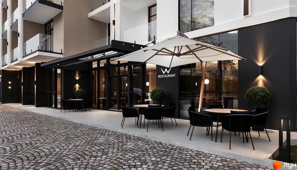 Зовнішній вигляд будинку Erwin Hall з терасою та вуличними меблями. Прибудинкова територія з бруківкою та освітленням.