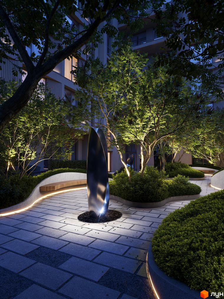 Житловий комплекс Avalon Yard Club з підсвіченою зоною відпочинку та скульптурою в центрі двору.