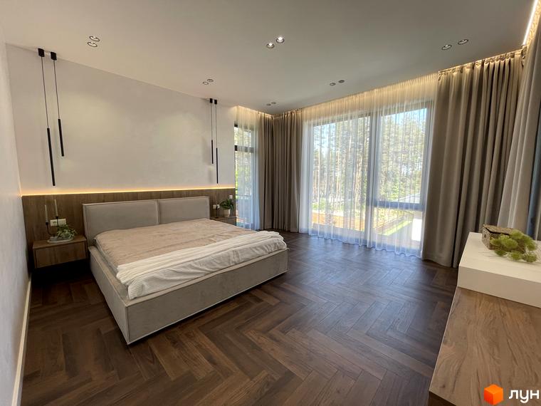 Інтер'єр спальні в Котеджному містечку Нова Ходосівка. Простора кімната з великим ліжком та панорамними вікнами.