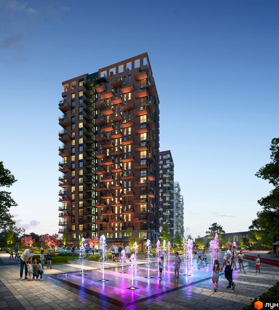 Житловий комплекс Central Park Vinnytsia з цегляним фасадом та балконами, освітлений ввечері. На прибудинковій території розташовані фонтани та зелені насадження.