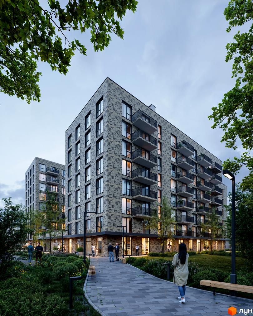 Житловий комплекс WABI 2 із сірої цегли з балконами та прибудинковою територією з деревами та лавками.