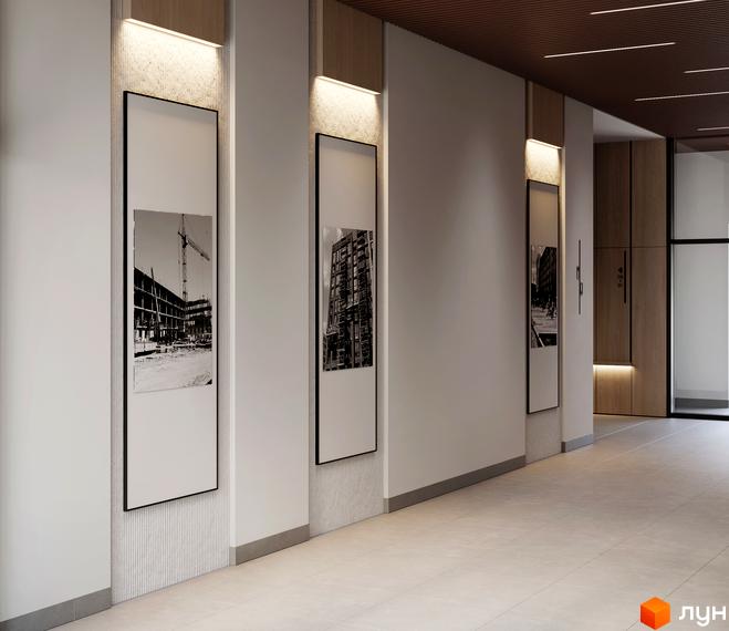 Новобудова MARVEL Home: просторий хол з білими стінами та світлою плиткою. На стінах розміщені великі панелі з чорно-білими фотографіями будівництва.