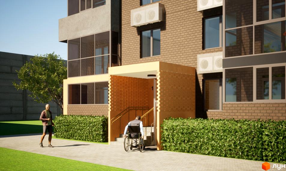 Зображення фасаду будинку ЖК Видовий з цегляною кладкою, скляними вікнами та входом з пандусом для людей з інвалідністю. На передньому плані зелена зона та тротуар.
