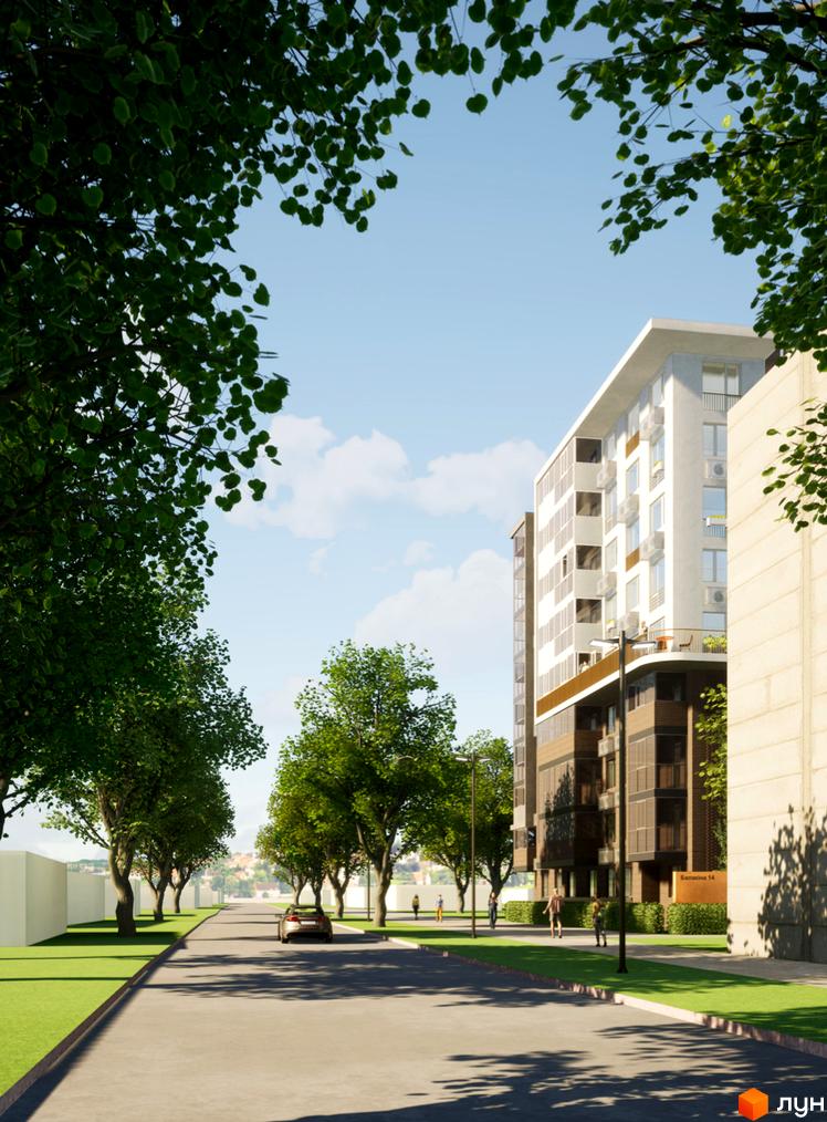 Висотна будівля житлового комплексу з великою кількістю вікон. На передньому плані дорога з деревами та зеленою зоною.