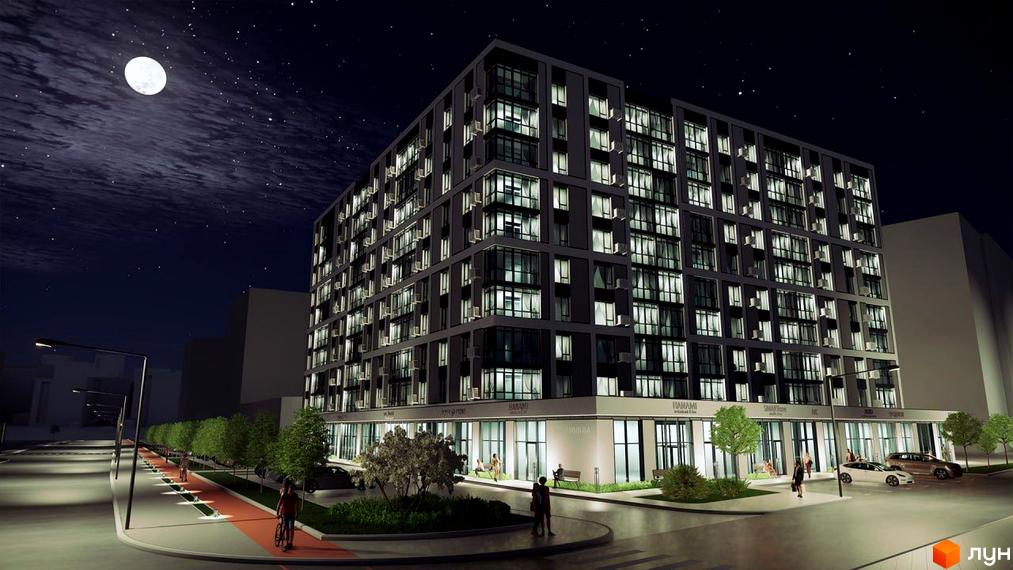 Житловий комплекс Millennium вночі: багатоповерхова будівля з освітленими вікнами та темним фасадом. Поруч велодоріжка, ліхтарі та дерева.