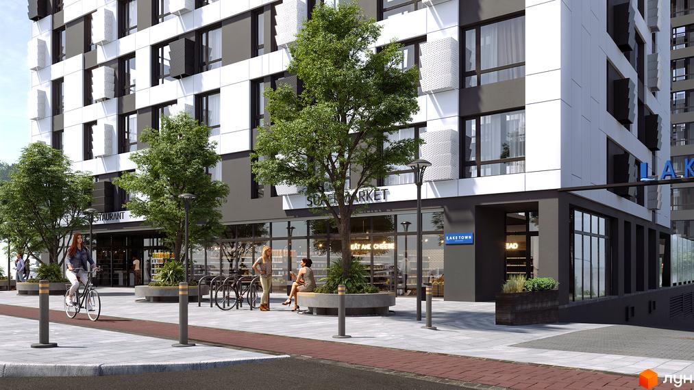 Новобудова LAKETOWN з сучасною фасадною системою та великими вікнами. Прибудинкова територія з деревами, лавками та велопарковкою.