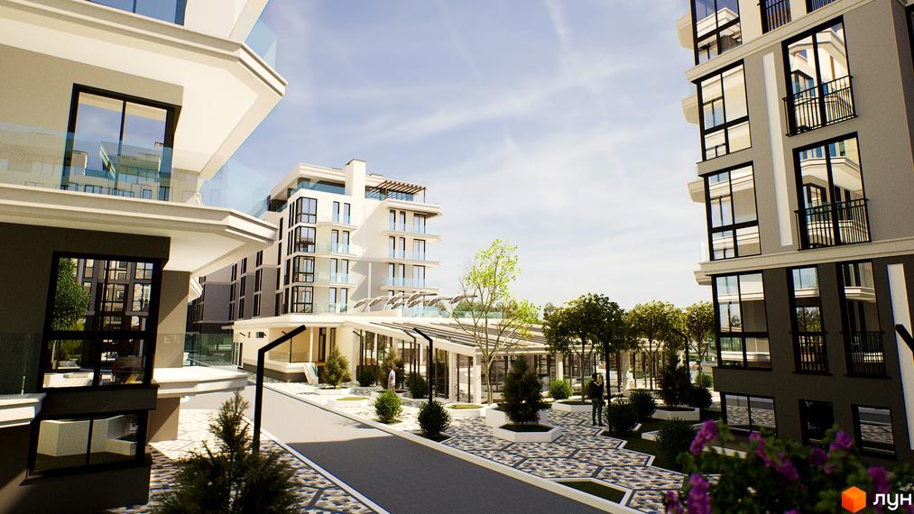 Житловий комплекс Stugna Residence з білими фасадами, скляними балконами та зеленою прибудинковою територією. На зображенні видно сучасну архітектуру будівель та облаштований двір.