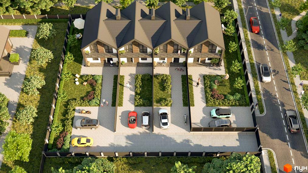 Вигляд зверху на таунхауси „Скандинавія“ з темними дахами та світлими фасадами, оточені паркувальними місцями, зеленими газонами та дорогою.