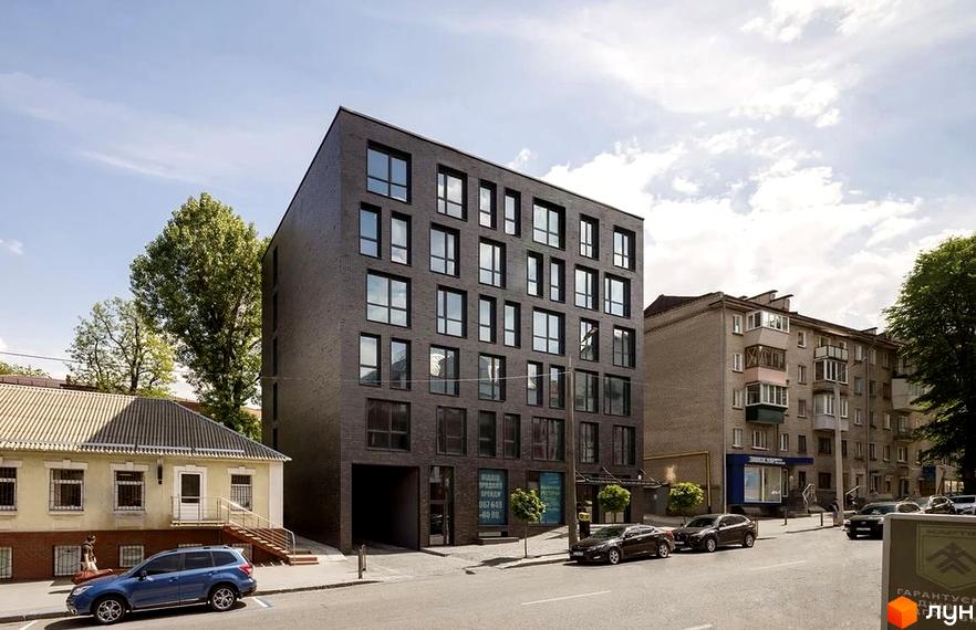 Новобудова ЖК ArtHof з темною цегляною фасадною обробкою та великими вікнами. Поруч розташована прибудинкова територія з деревами та дорогою.