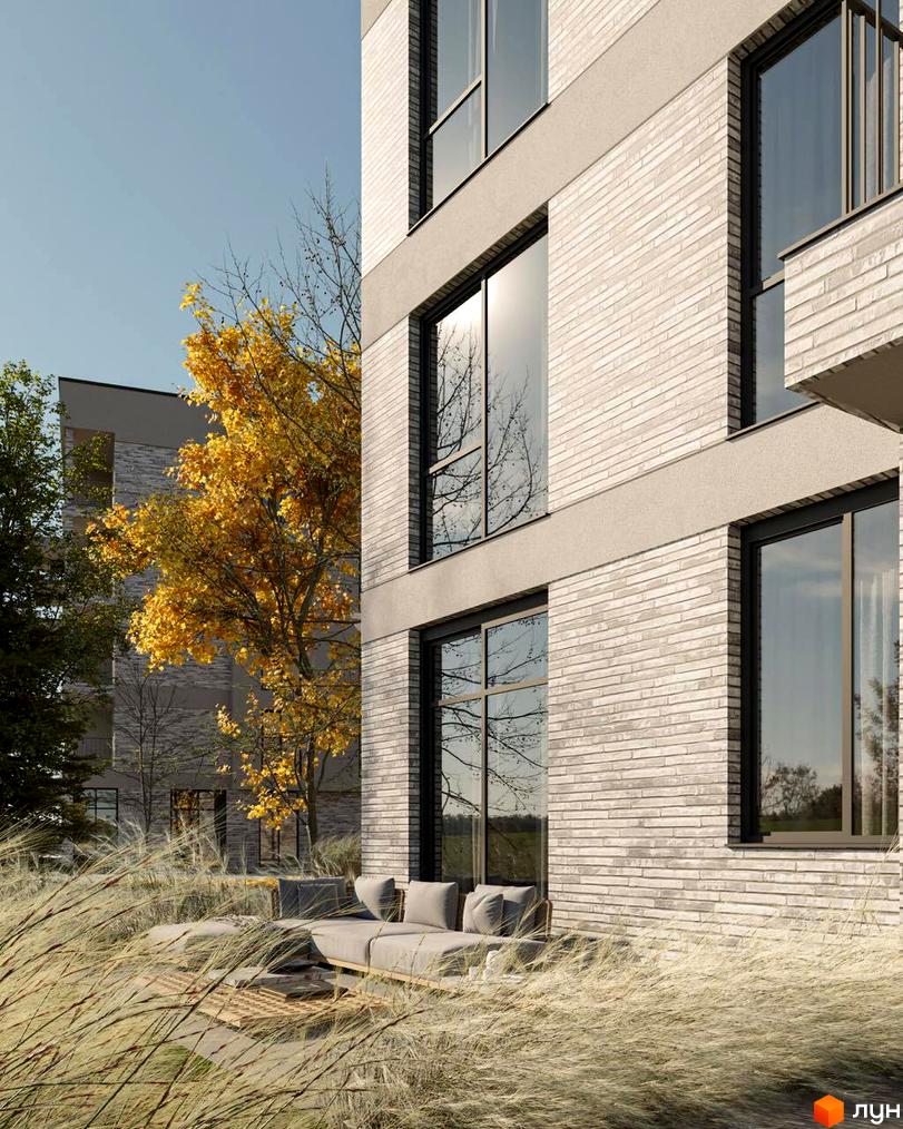 Зовнішній вигляд будинку Клубний будинок San Marco з цегляною кладкою та великими вікнами. На передньому плані газон та дерева, що створюють атмосферу затишку.