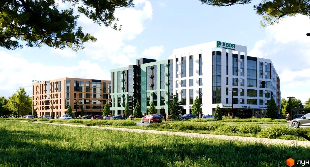 Комплекс Хвоя з фасадами різних кольорів та скляними вікнами, розташований біля зеленої зони з деревами та дорогою з автомобілями.