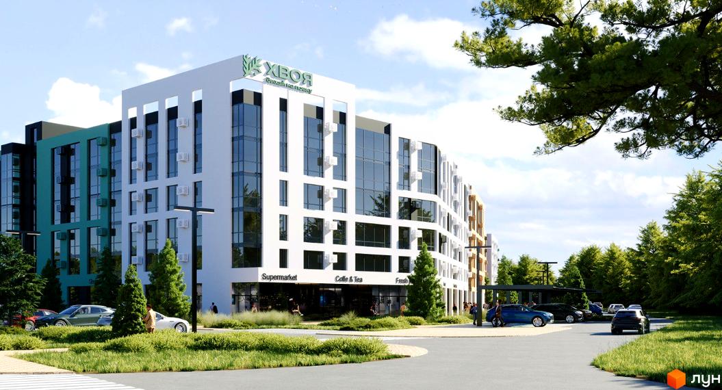 Житловий комплекс Хвоя. Зовнішній вигляд новобудови з фасадами білого та зеленого кольору, скляними вікнами та прибудинковою територією з деревами та автомобілями.