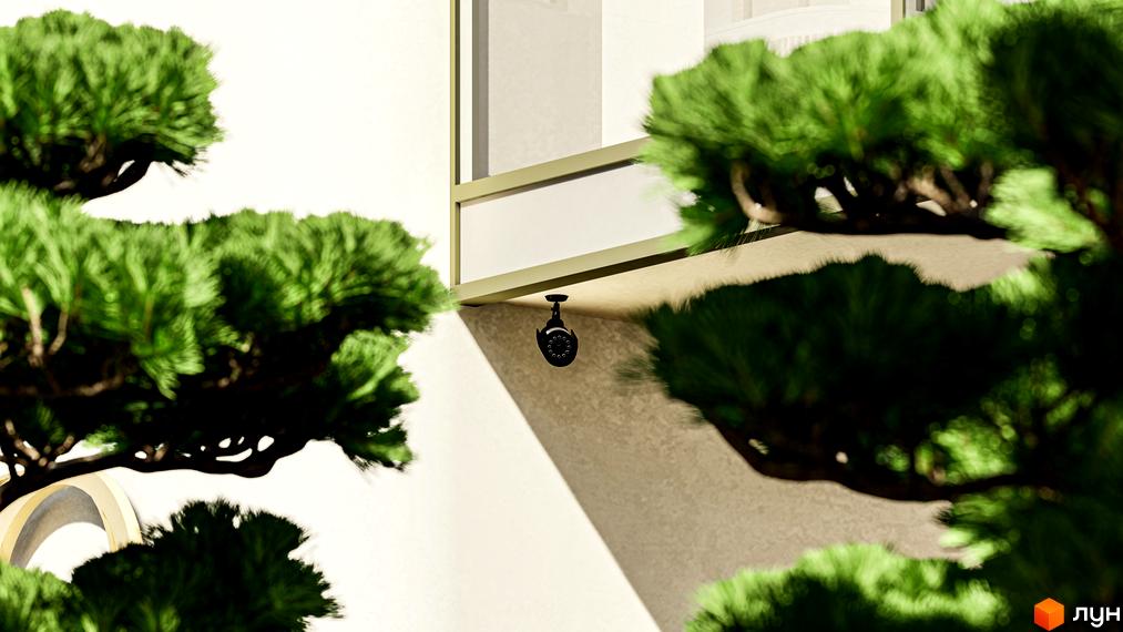 Житловий комплекс RESIDENTS AVENUE з камерою відеоспостереження на фасаді та зеленню навколо. Зовнішній вигляд новобудови та прибудинкової території.