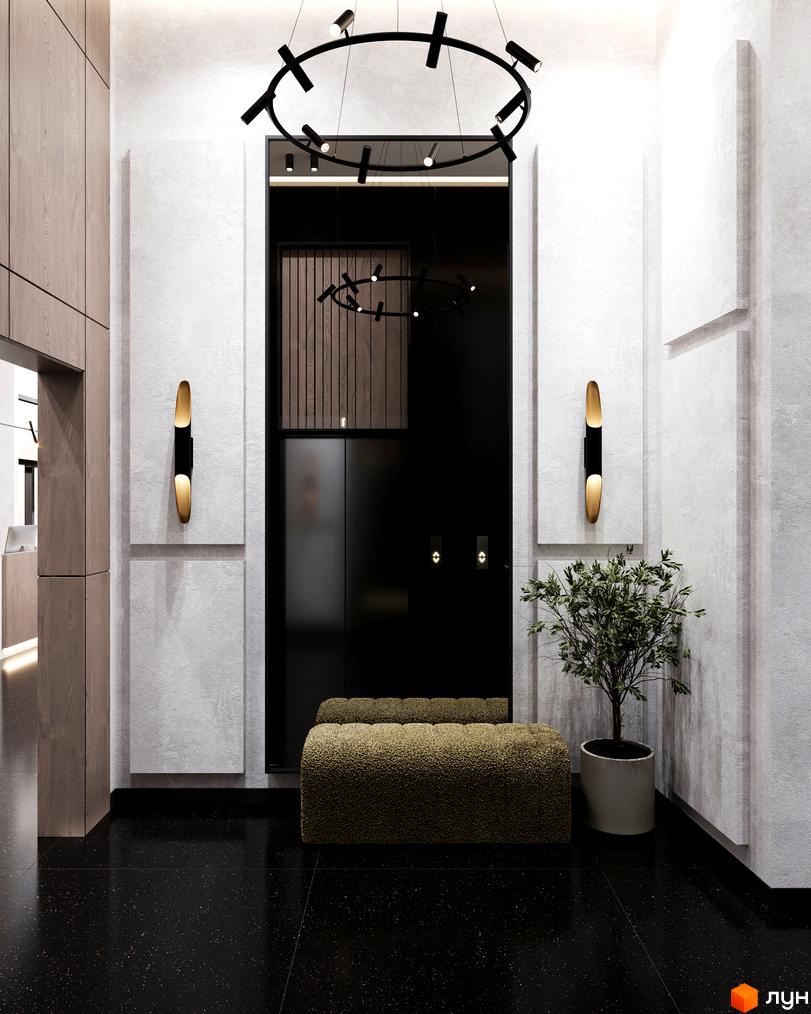 Інтер'єр холу в апарт-комплексі Times з чорною підлогою, рослиною у вазоні та круглим світильником. Вигляд вхідної зони з ліфтом.