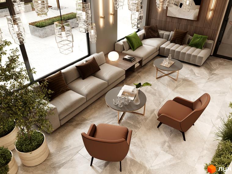 Інтер'єр вітальні в Житловому комплексі SVOÏ CITY: дивани, крісла та столики. Панорамні вікна з видом на озеленену територію.