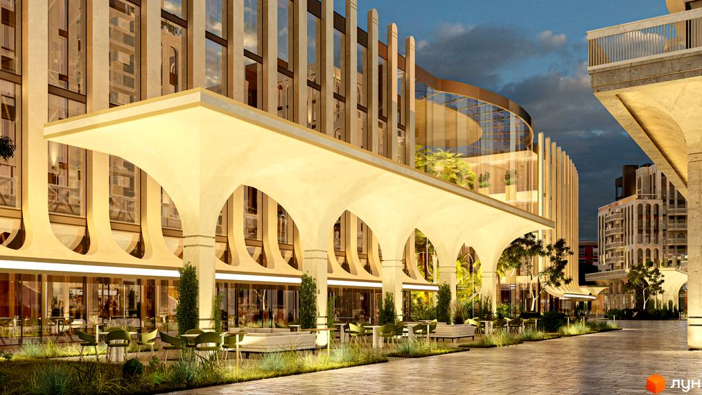 Житловий комплекс RESIDENTS AVENUE з аркадою та терасою, що виходить на доглянуту прибудинкову територію з місцями для відпочинку.