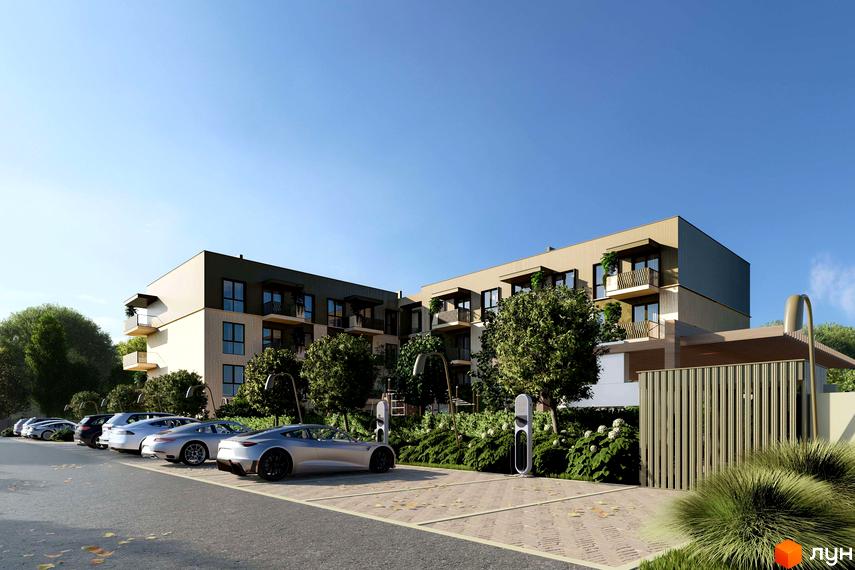 Житловий комплекс Минай з бежевими та темно-сірими фасадами, балконами та зеленими насадженнями. На території є парковка з електрозарядними станціями та доглянуті кущі.