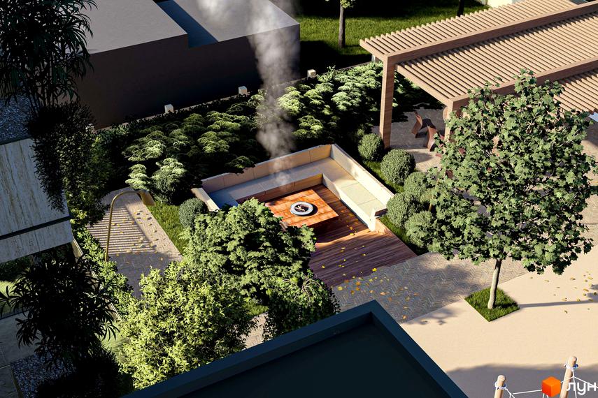 Вигляд на частину будівлі Житлового комплексу Минай з темним фасадом та великою прибудинковою територією, що включає зону відпочинку з вогнищем, альтанку та озеленення.