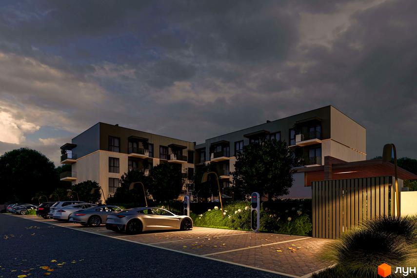 Житловий комплекс Минай з багатоповерховою будівлею, що має темний верхній та світлий нижній фасади. На території є паркінг з електрозарядками.