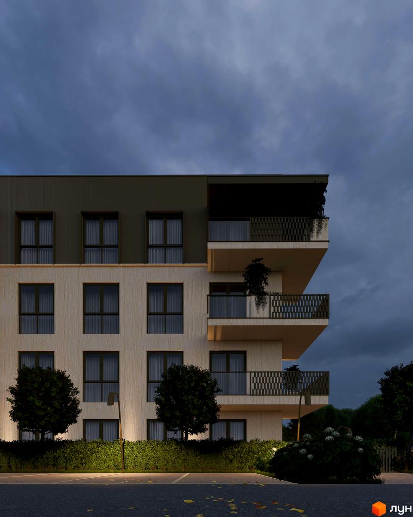Фасад житлового комплексу Минай з двома типами облицювання, балконами та вікнами. Ввечері освітлена прибудинкова територія з деревами та парковкою.