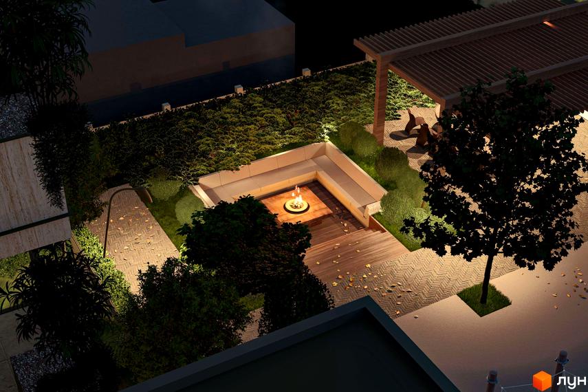 Освітлена прибудинкова територія Житлового комплексу Минай вночі, з зоною відпочинку, вогнищем, дерев'яними настилами та зеленими насадженнями.