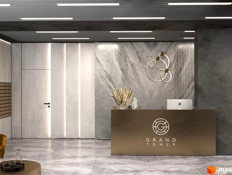 Лобі Житлового комплексу Grand Tower з рецепцією, мармуровою стіною та лінійним освітленням. Зображено вхідну групу та поштові скриньки.