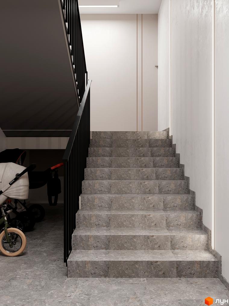 Сучасний дизайн сходової клітини в ЖК ATMOSFERA з сірими мармуровими сходами та чорними перилами. Поруч дитячий візок та велосипед.
