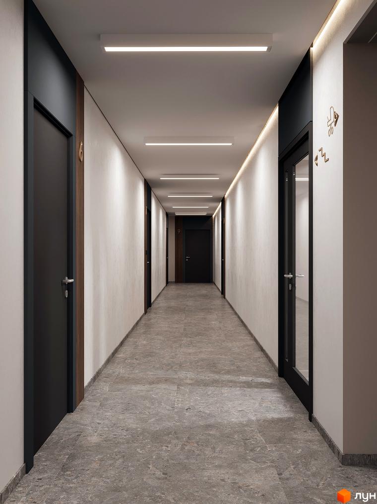 Сучасний коридор житлового комплексу ATMOSFERA з дверима та підлогою з сірого мармуру. Освітлення створює затишну атмосферу.