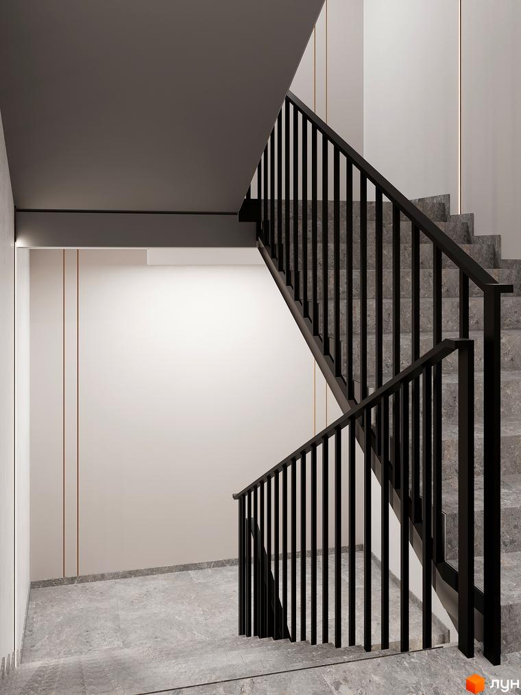 Сучасні сходи з чорними перилами та сірою плиткою в ЖК ATMOSFERA. Просторий хол з білими стінами та декоративними елементами.