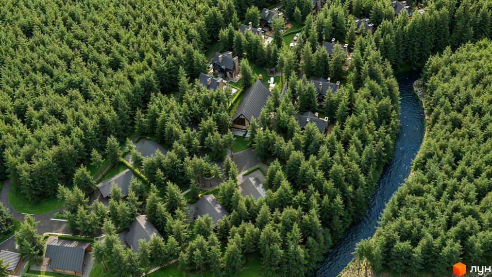 Котеджне містечко Guta Nova: будинки з темними дахами, включаючи будівлю з великим скляним фасадом, серед хвойного лісу та річки.