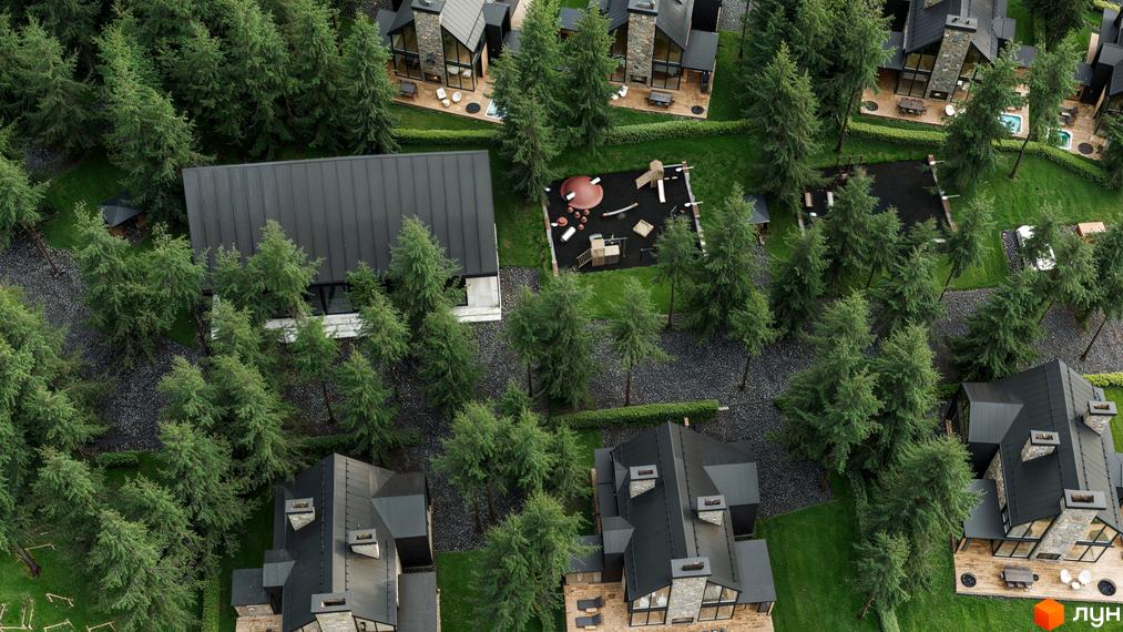 Вид зверху на котеджі Guta Nova з темними дахами та кам'яними фасадами. Територія оточена хвойними деревами, газонами та має дитячий майданчик.