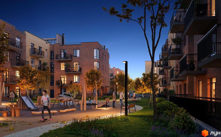 Житловий комплекс Долішній з цегляними фасадами та балконами, дитячим майданчиком та зонами відпочинку на прибудинковій території ввечері.