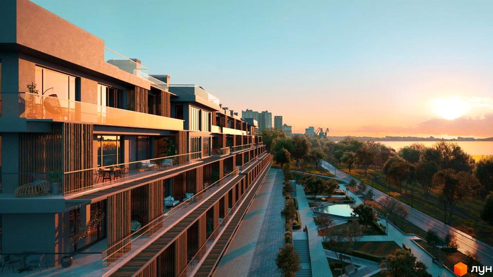 Житловий комплекс OZONE з будинками, що мають довгі балкони та скляні огорожі. Поруч розташована набережна, зелена зона з деревами та водойма на заході сонця.