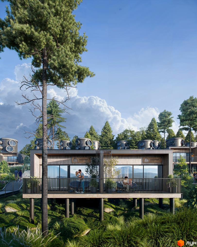 Будинки Котеджного містечка Малахіт мають дерев'яні фасади та круглі житлові модулі на дахах. Прибудинкова територія вкрита густою зеленою рослинністю.