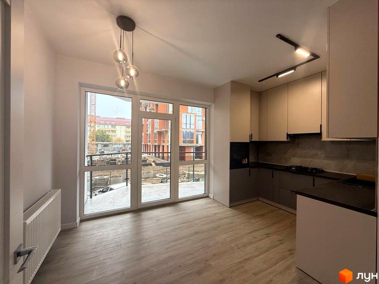 Інтер'єр кухні в ЖК Comfort City з великими вікнами, що виходять на будівельний майданчик. Сучасні меблі та освітлення.