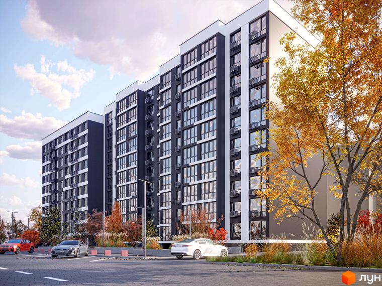 Житловий комплекс Comfort Lite з фасадами темного та світлого кольорів, вікнами та кондиціонерами, на тлі осінніх дерев та парковки з автомобілями.