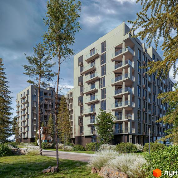 Житловий комплекс LuxAR з сірими фасадами та скляними балконами оточений зеленню та деревами. Навколо комплексу облаштована прибудинкова територія з доріжками та газонами.