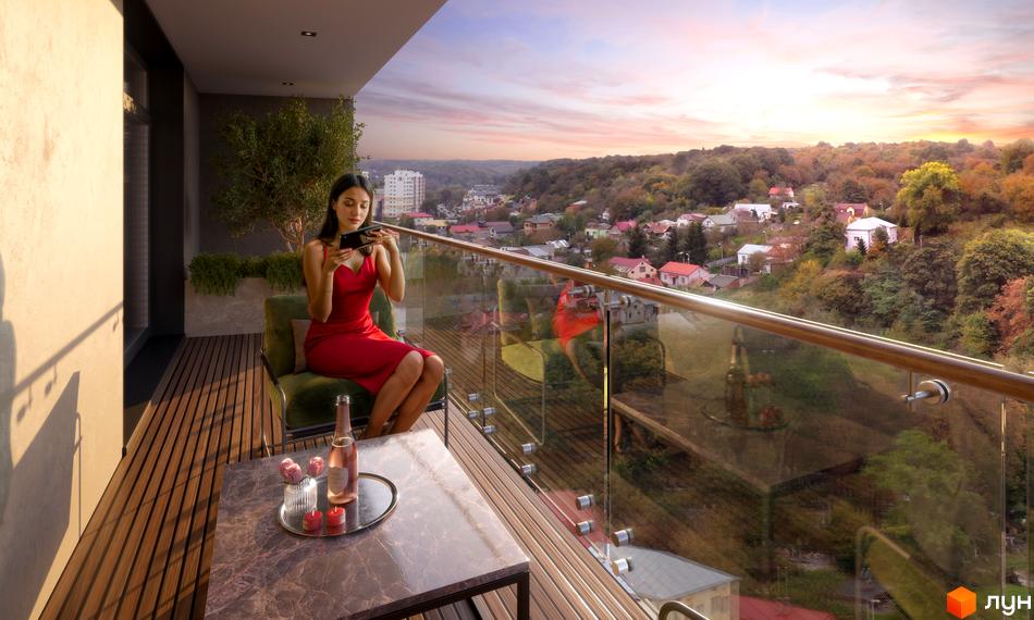 Житловий комплекс AUROOM AIR з жінкою на балконі, що насолоджується краєвидом на місто та осінній ліс.