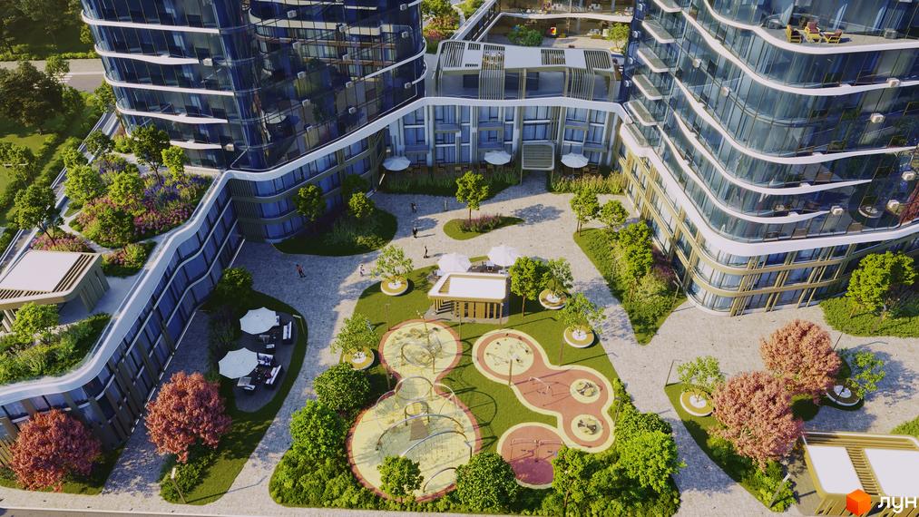 Вид на житловий комплекс The Light з повітря. Сучасна архітектура з вигнутими фасадами та великою кількістю скла. На прибудинковій території розташовані дитячі майданчики, зони відпочинку з парасольками та зелені насадження.