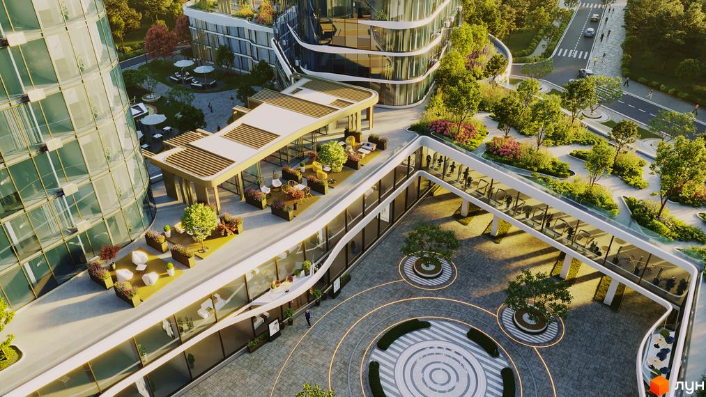 Зовнішній вигляд житлового комплексу The Light з скляними фасадами та зеленою прибудинковою територією. Сучасна архітектура та ландшафтний дизайн створюють комфортне середовище для життя.