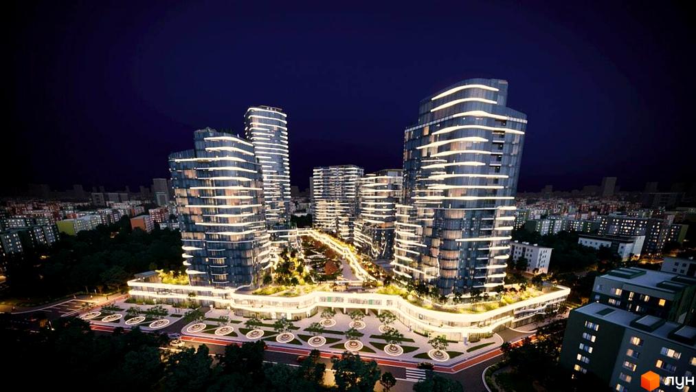 Нічний вид на житловий комплекс The Light з підсвіченими фасадами хмарочосів та доглянутою прибудинковою територією з деревами та зонами відпочинку.