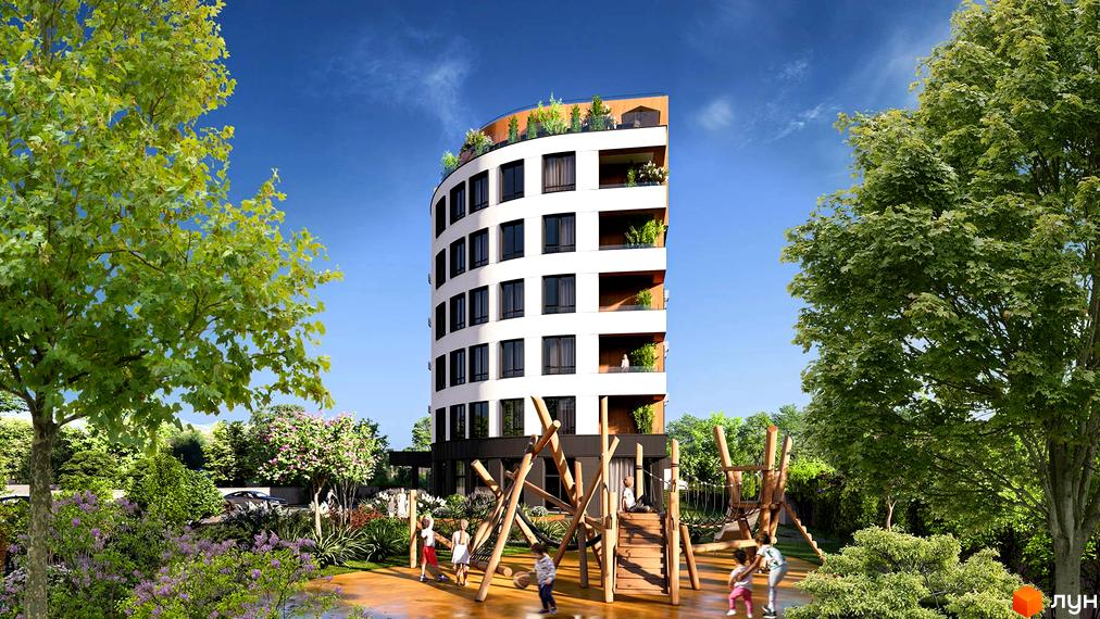 Житловий комплекс FREEDOM з вигнутим фасадом та дитячим майданчиком. Навколо зелені дерева та кущі, блакитне небо.