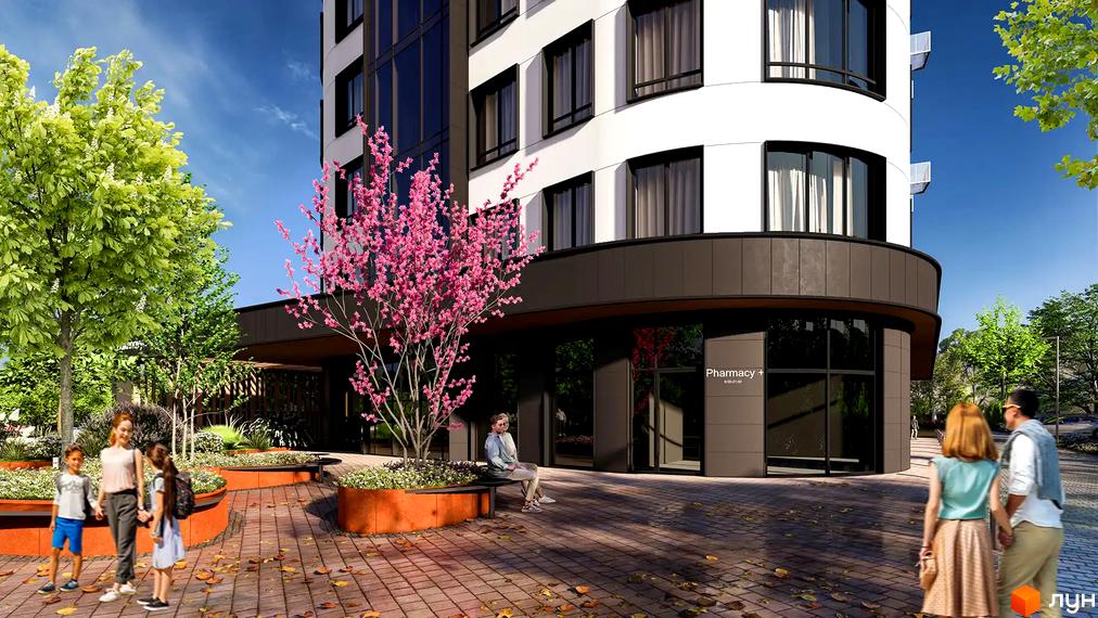 Житловий комплекс FREEDOM з білою фасадною частиною та скляними елементами, оточений деревами та квітковими клумбами.