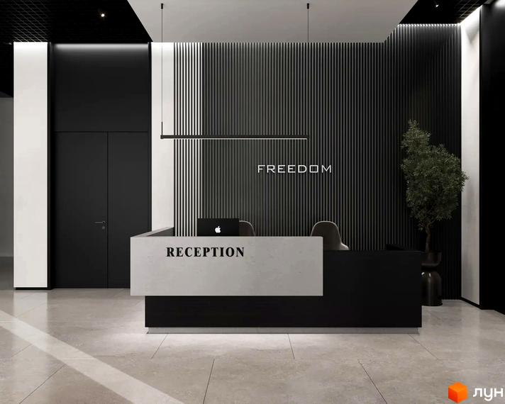 Рецепція Житлового комплексу FREEDOM з чорно-білим дизайном, вертикальними панелями на стіні та написом FREEDOM.