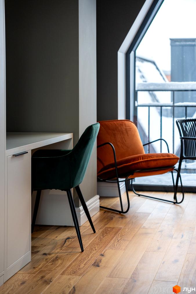 Інтер'єр квартири в житловому комплексі AMA FAMILY RESORT з двома кріслами та вікном з видом на зимовий пейзаж.