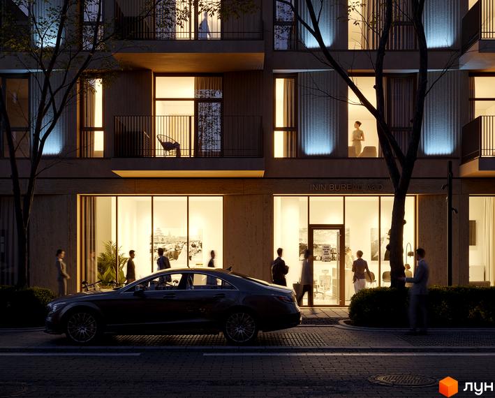 Житловий комплекс Avalon Yard Club з фасадом з натуральних матеріалів та підсвіткою, навколо зелена зона з деревами та комфортне освітлення вулиці.