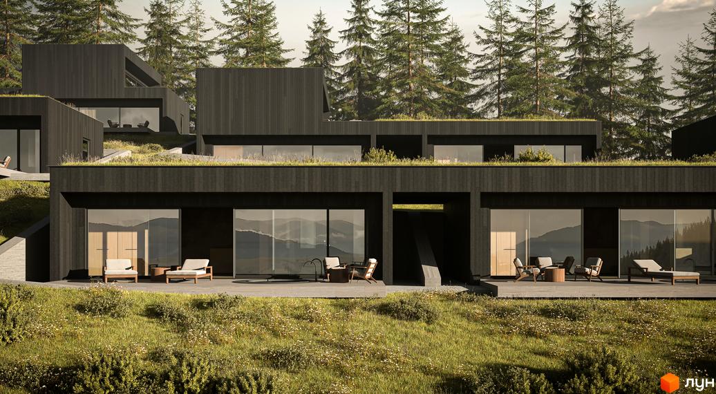 Будинок з темного дерева та панорамними вікнами, оточений зеленню та деревами. Тераса з меблями та видом на гори.